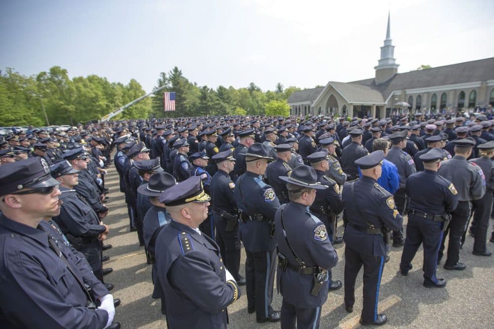 Hundreds of police officers stood outside the church were Ronald Tarentino's funeral was held Friday in Charlton. Tarentino, an Auburn police officer, was shot and killed during a traffic stop.  (Jesse Costa/WBUR)