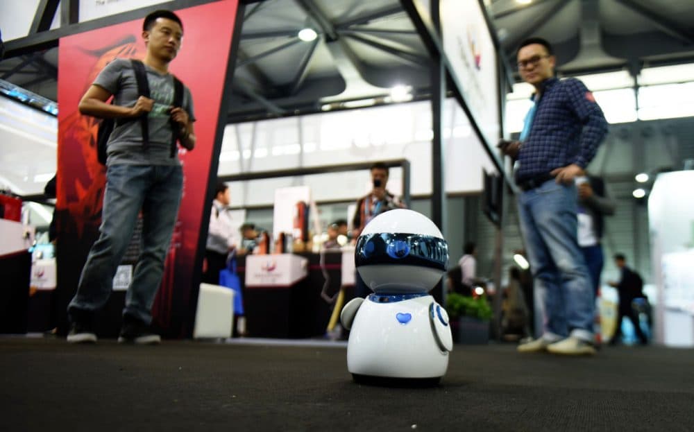 This photo taken on May 11, 2016 shows visitors watching a robot display during the first day of the Consumer Electronics Show (CES) in Asia in Shanghai.
(STR/AFP/Getty Images)
