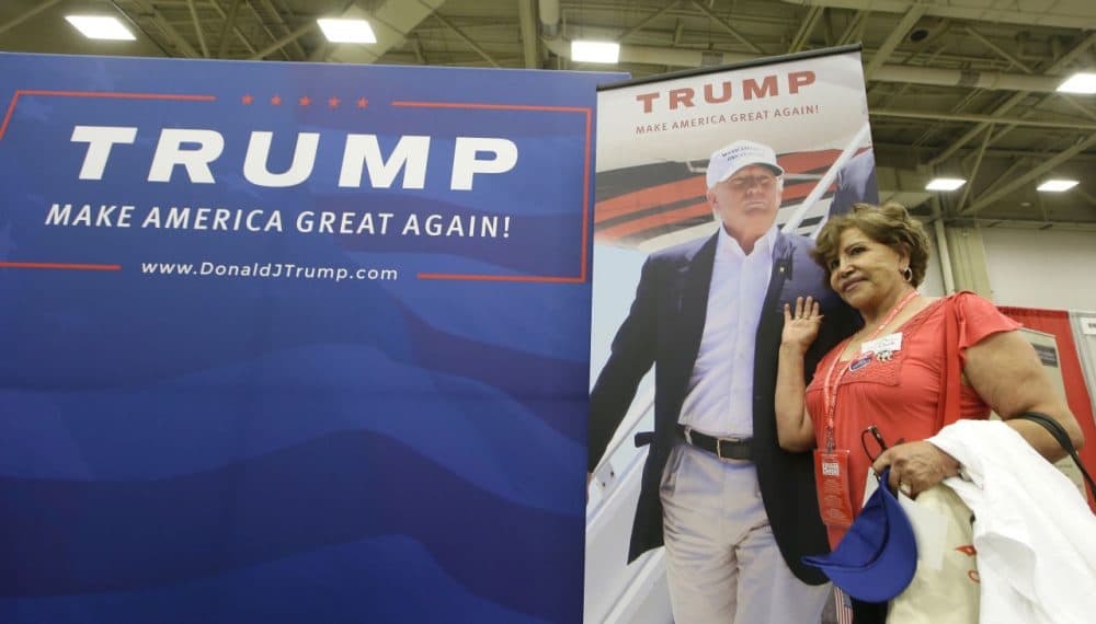 El Paso delegate Regina Jarvis poses for a photo with a photo of Donald Trump during the Texas Republican Convention on May 12 in Dallas. (LM Otero/AP)