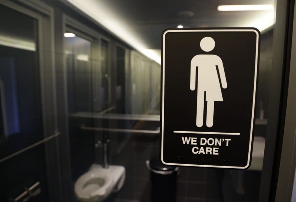 Signage outside a restroom at 21c Museum Hotel in Durham, N.C. The Mass. Senate passed the Transgender Accommodations bill on Thursday . (Gerry Broome/AP)