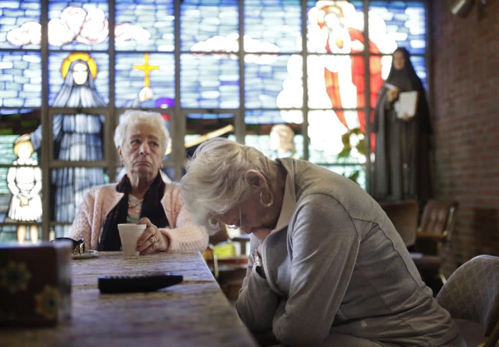 Mary Fernandes, left, and Nancy Shilts, parishioners at St. Frances X. Cabrini in Scituate, react in the church Monday while talking about its closing. The Supreme Court has refused to hear an appeal from parishioners who are occupying the church, which the Archdiocese of Boston closed more than a decade ago. (Steven Senne/AP)