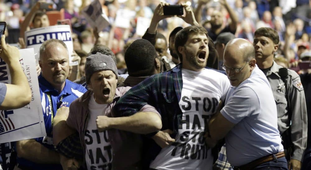 Joelle Renstrom: &quot;Has Trump’s venom so poisoned the national dialogue that violence and vitriol have become standard currency?&quot; Pictured: Protesters are removed as Republican presidential candidate Donald Trump speaks during a campaign rally in Fayetteville, N.C. in March, 2016. The scene was violent and chaotic.  (Gerry Broome/AP)