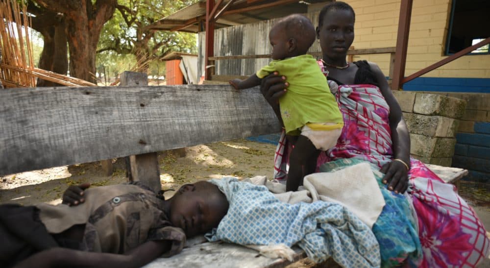 Nyawel Top sits with her two sick children in a Doctors Without Borders clinic in Leer town, South Sudan on Tuesday Dec. 15, 2015. The country is in the throes of a civil war that in two and a half years has killed tens of thousands of people and forced more than 2 million from their homes. (Jason Patinkin/AP)