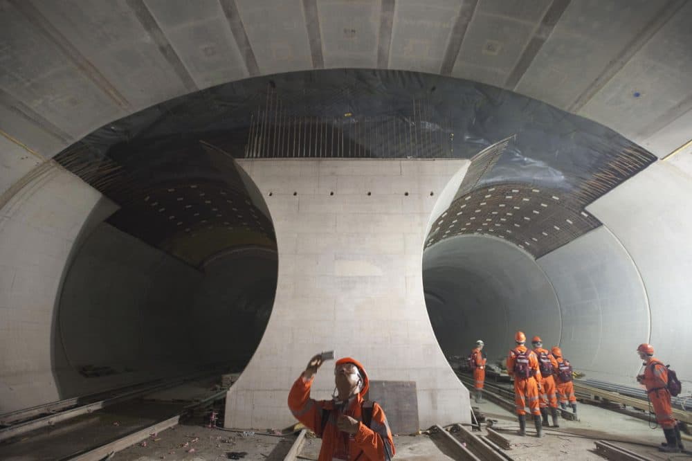 A Chinese journalist takes a picture of the 57-kilometre (35-mile) railway tunnel under construction in the Alps at Sedrun on May 6, 2009. The tunnel, which opened this week, is meant to increase rail capacity for freight and passengers through the Alps and between northern Europe and Italy. (Sebastien Bozon/AFP/Getty Images)