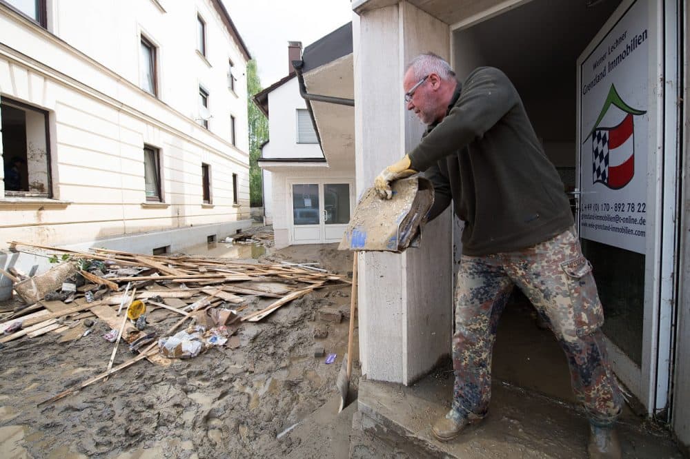 Werner Lechner throws a binder covered in mud out of his office following floods on June 3, 2016 in Simbach am Inn, Germany. Severe and sudden flooding in the region around Simbach hit communities on June 1, overturning cars, inundating homes and businesses and leaving at least six people dead. (Sebastian Widmann/Getty Images)