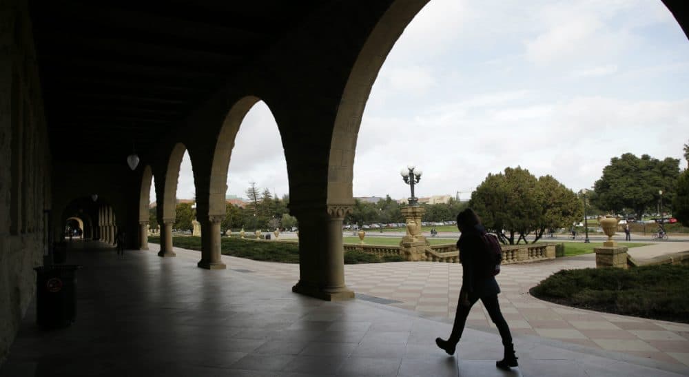 A six-month jail term for a former Stanford University student convicted of sexually assaulting an unconscious woman is being decried as a slap on the wrist. In this photo, a student walks on Stanford's campus on Wednesday, Jan. 13, 2016. (Marcio Jose Sanchez/AP)