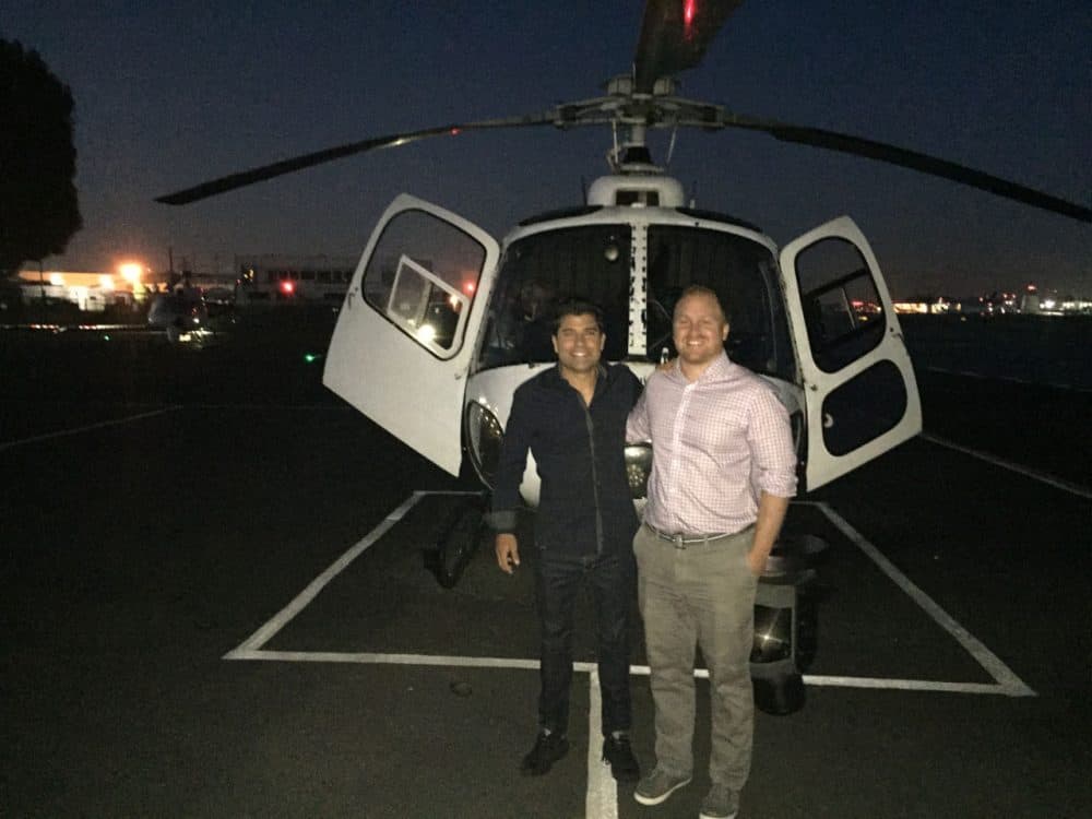 Here &amp; Now co-host Jeremy Hobson stands with Rick Dickert, a certified broadcast meteorologist and traffic reporter for Fox 11 Morning News in Los Angeles, in front of a traffic helicopter. (Ethan Lindsey/Here &amp; Now)