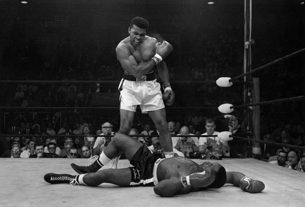 Heavyweight champion Muhammad Ali stands over fallen challenger Sonny Liston, shouting and gesturing shortly after dropping Liston with a short hard right to the jaw on May 25, 1965, in Lewiston, Maine.  (AP Photo/John Rooney)