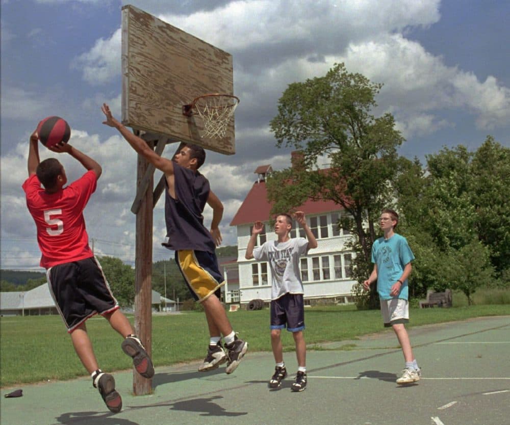 Gonzalo Ortiz, left, 16, shoots a basketball as his brother Joe Ortiz, 17, both of Brooklyn, N.Y., defends while playing in Worcester, Vt., with their Fresh Air Fund host Matt Meninger, 15, far right, and friend Patrick Harriman, 15, of East Montpelier, Vt., Friday, July 12, 1996.  Gonzalo Ortiz has been coming to Vermont through the program each summer since he was four-years-old. (Craig Line/AP)