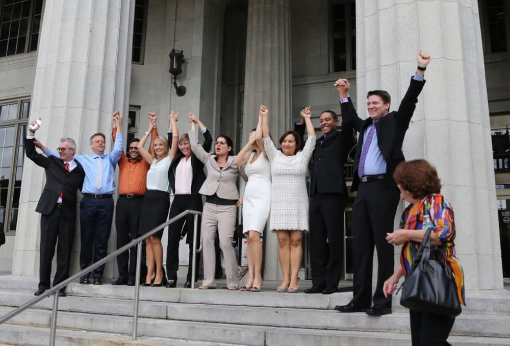 Same-sex couples and their attorneys who had previously challenged the wedding ban celebrate on court steps after Circuit Court Judge Sarah Zabel lifted the stay, allowing same-sex couples to marry January 5, 2015 in Miami, Florida.  (Emily Michot-Pool/The Miami Herald/Getty Images)