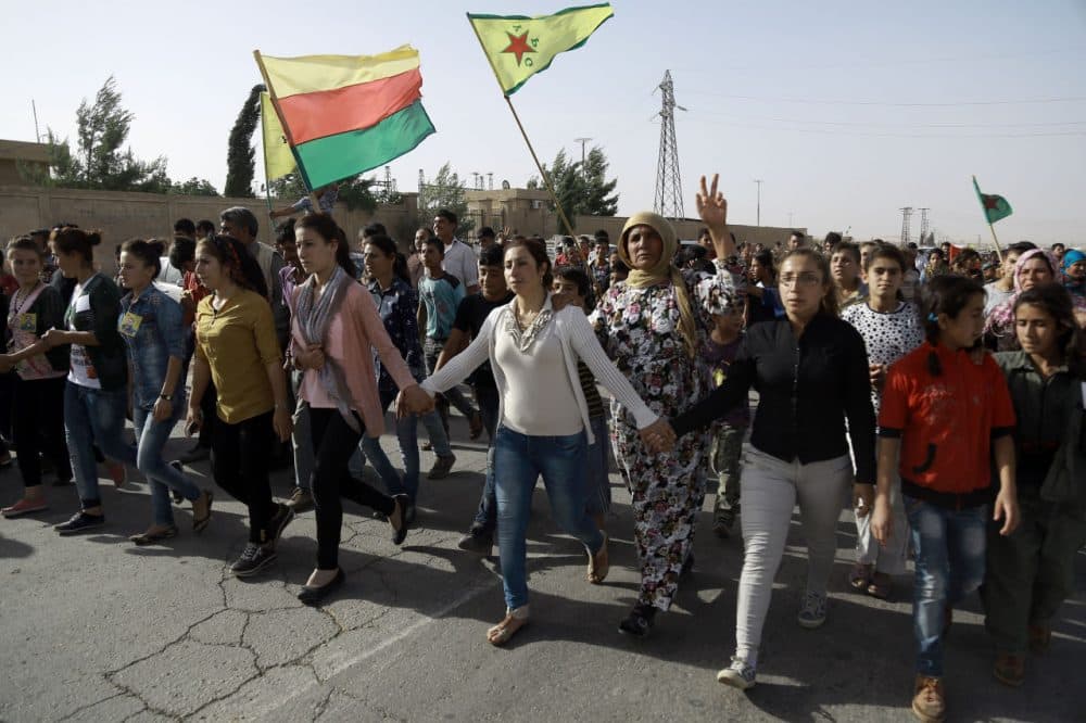 Syrian Kurds march during the funeral of fighters, who died during an assault launched by Arab and Kurdish forces against Islamic State (IS) group fighters in the town of Manbij, in the Syrian Kurdish town of Kobane on June 4, 2016. (Delil Souleiman/AFP/Getty Images)