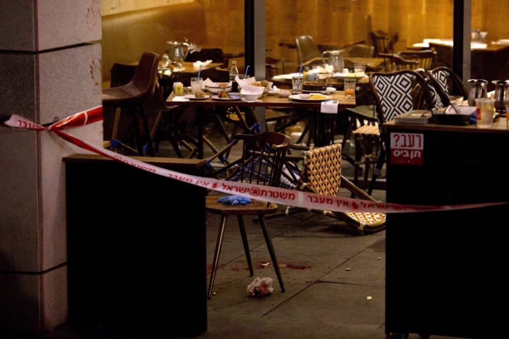 The scene of a shooting attack is seen in Tel Aviv, Israel, Wednesday, June 8, 2016. Two Palestinian gunmen opened fire in central Tel Aviv Wednesday night, killing three people and wounding at least five others, Israel police said. (AP Photo/Sebastian Scheiner)
