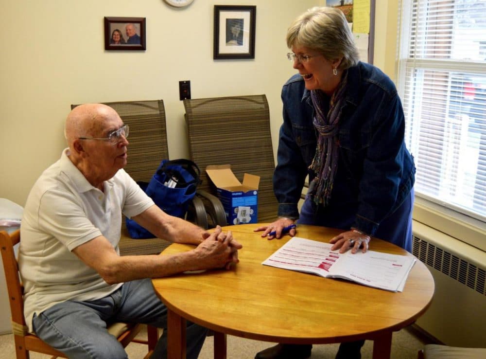 Karyn Crossman, a SASH coordinator pays a visit to 88-year-old Lloyd Piggrem, of Rutland. Piggrem is one of 100 clients Crossman works with through a statewide nonprofit that provides a variety of home-based support services. (Nina Keck/VPR)