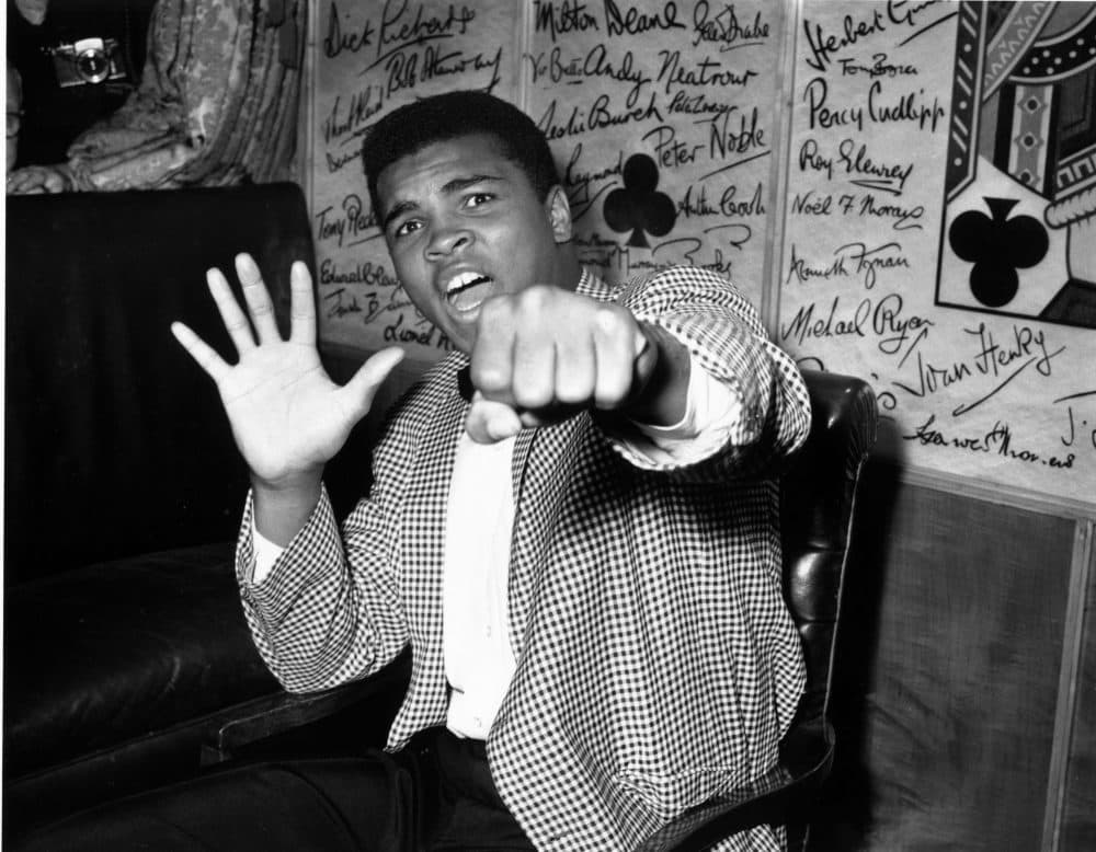 American boxer Cassius Clay, who later changed his name to Muhammad Ali, holds up five fingers in a prediction of how many rounds it will take him to knock out British boxer Henry Cooper. (Kent Gavin/Keystone/Getty Images)
