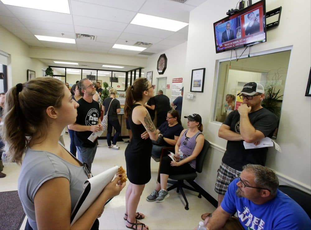 Volunteers waiting to donate blood at a blood bank watch President Barack Obama deliver remarks on a TV after the shooting in Orlando, Fla. (John Raoux/AP)