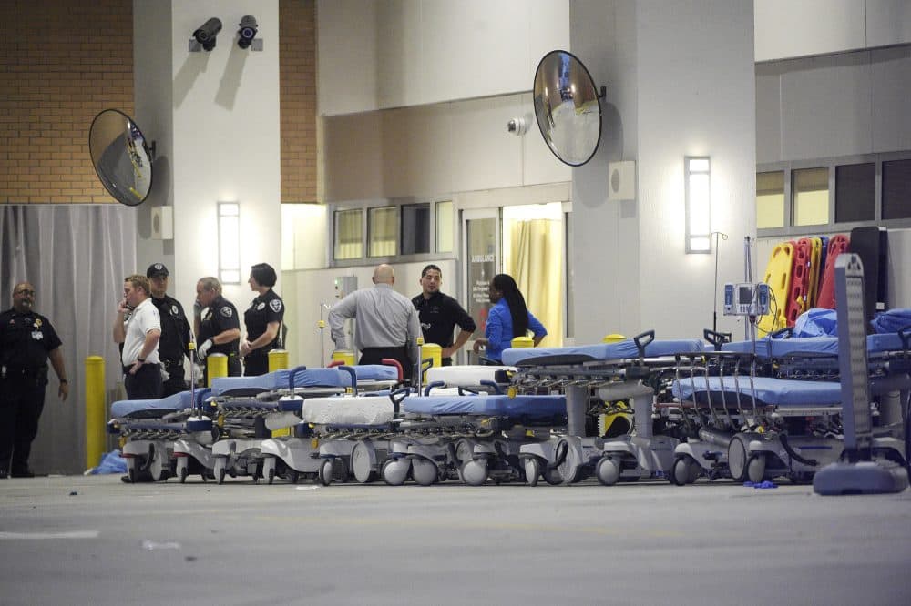 Emergency personnel wait with stretchers at the emergency entrance to Orlando Regional Medical Center hospital for the arrival of patients from the scene of a fatal shooting. (Phelan M. Ebenhack/AP)