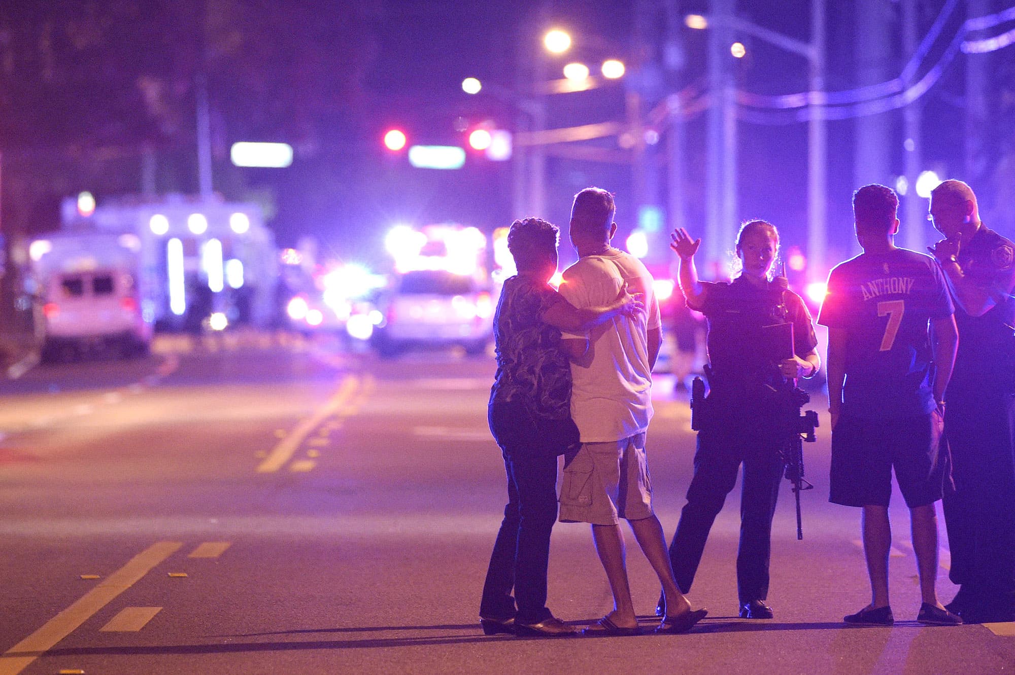Orlando Police officers direct family members away from a fatal shooting at Pulse Orlando nightclub early Sunday. (Phelan M. Ebenhack/AP)