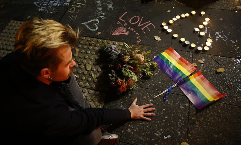 A man attends a candlelight vigil for the victims of the Pulse Nightclub shooting in Orlando, Florida, at Newtown Neighbourhood Centre on June 13, 2016 in Sydney, Australia. (Daniel Munoz/Getty Images)