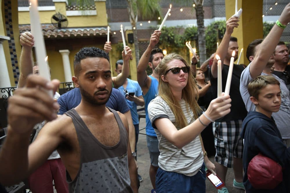 People hold candles during a vigil for the victims of the Pulse club shooting at the Ember restaurant and bar in Orlando, Florida on June 12, 2016. 49 people died when a gunman allegedly inspired by the Islamic State group opened fire inside a gay nightclub in Florida, in the worst terror attack on US soil since September 11, 2001. (Mandel Ngan/AFP/Getty Images)