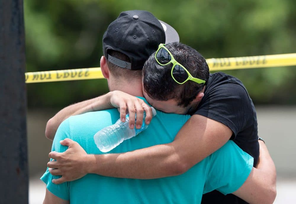 Supported by a friend, a man weeps for victims of the mass shooting just a block from the scene in Orlando, Florida, on June 12, 2016. (Gregg Newton/AFP/Getty Images)