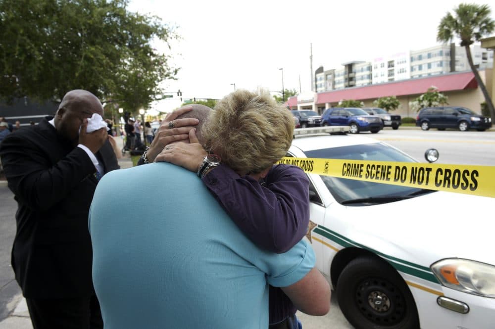 Terry DeCarlo, executive director of the LGBT Center of Central Florida, center, is comforted by Orlando City Commissioner Patty Sheehan, right, after a shooting involving multiple fatalities at a nightclub in Orlando, Fla., Sunday, June 12, 2016. (Phelan M. Ebenhack/AP)