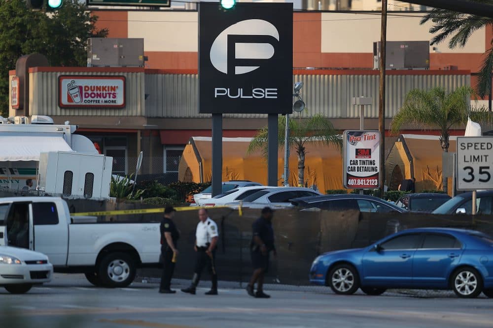 Law enforcement officials investigate near the Pulse Nightclub where Omar Mateen allegedly killed at least 50 people on June 13, 2016 in Orlando, Florida. The mass shooting killed at least 50 people and injuring 53 others in what is the deadliest mass shooting in the country's history. (Joe Raedle/Getty Images)