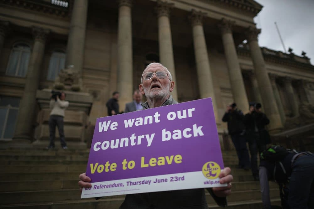 A Vote to Leave campaigner holds a placard as Leader of the United Kingdom Independence Party (UKIP), Nigel Farage campaigns for votes to leave the European Union in the referendum on May 25, 2016 in Bolton, England, encouraging British people to vote to leave the EU on 23rd June 2016. (Christopher Furlong/Getty Images