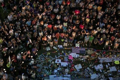 Mourners hold candles while observing a moment of silence during a vigil outside the Dr. Phillips Center for the Performing Arts for the mass shooting victims at the Pulse nightclub June 13, 2016 in Orlando, Florida. (Brendan Smialowski/AFP/Getty)