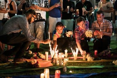 People make a memorial after a vigil outside the Dr. Phillips Center for the Performing Arts for the mass shooting victims at the Pulse nightclub June 13, 2016 in Orlando, Florida.
The American gunman who launched a murderous assault on a gay nightclub in Orlando was radicalized by Islamist propaganda, officials said Monday, as they grappled with the worst terror attack on US soil since 9/11. 
(BRENDAN SMIALOWSKI/AFP/Getty Images)
