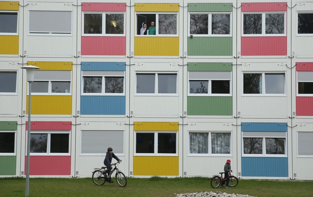 Children play as residents look from their window at the container settlement shelter for refugees and migrants in Zehlendorf district on April 14, 2016 in Berlin, Germany. (Sean Gallup/Getty Images)