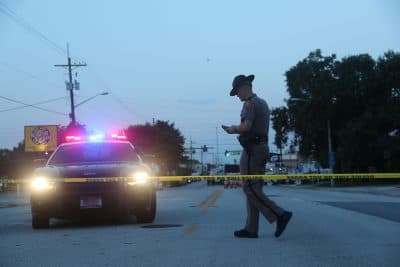 Law enforcement officials block off the road near the Pulse gay nightclub as they continue the investigation into where Omar Mateen killed 49 people on June 15, 2016 in Orlando, Florida. The mass shooting killed 49 people and injuring 53 others in what is the deadliest mass shooting in the country's history. (Joe Raedle/Getty Images)
