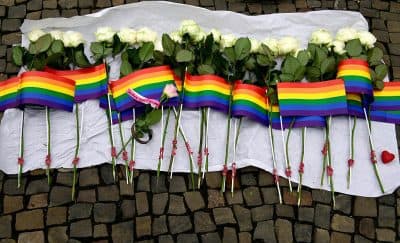 White roses and rainbow flags are displayed in front of the US Embassy in Berlin on June 13, 2016 as people pay tribute to the victims of the Orlando killing. (John MacDougall/AFP/Getty Images)