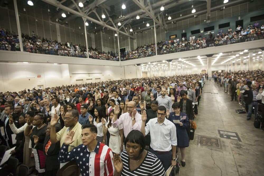 Brand new U.S. citizens take the oath of allegiance at the Hynes Convention Center Thursday. (Joe Difazio for WBUR)