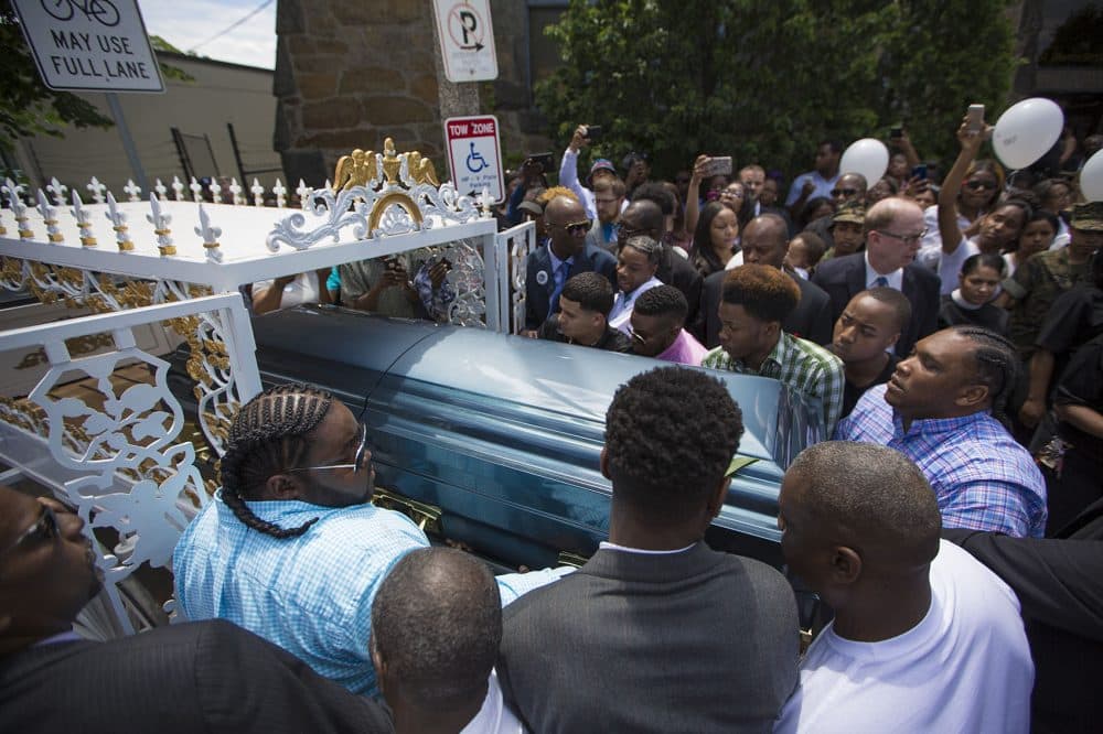 Pallbearers put Raekwon's casket into a horse-drawn carriage that took him to the burial site. (Jesse Costa/WBUR)