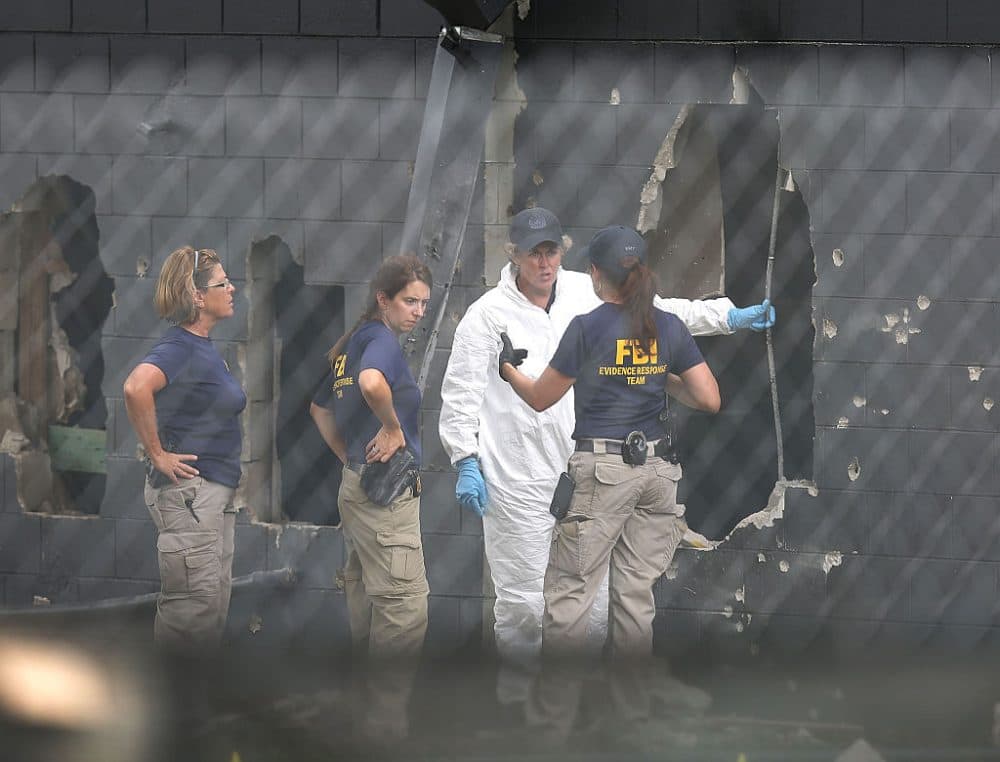 FBI agents investigate near the damaged rear wall of the Pulse Nightclub where Omar Mateen allegedly killed at least 50 people on June 12, 2016 in Orlando, Florida. (Joe Raedle/Getty Images)