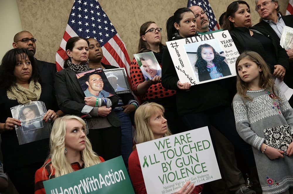Family members who have lost loved ones to gun violence gather with members of Congress during a press conference four days before the second anniversary of the shooting at Sandy Hook Elementary School December 10, 2014 in Washington, DC. (Win McNamee/Getty Images)