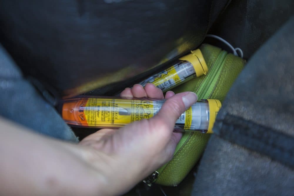 Lesley Solomon grabs one of the EpiPens she always carries from her bag. (Jesse Costa/WBUR)