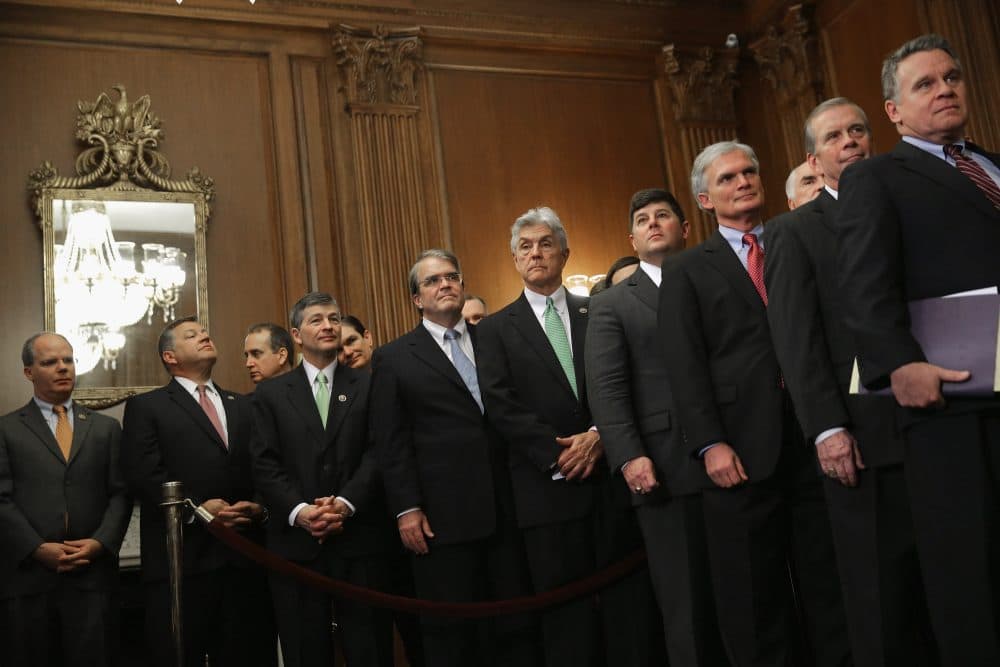 Republican members of the House of Representatives line up to watch Speaker of the House Paul Ryan (R-WI) sign legislation to repeal the Affordable Care Act, also known as Obamacare, and to cut off federal funding of Planned Parenthood during an enrollment ceremony in the Rayburn Room at the U.S. Capitol January 7, 2016 in Washington, DC. President Barack Obama has promised to veto the bill.  (Chip Somodevilla/Getty Images)