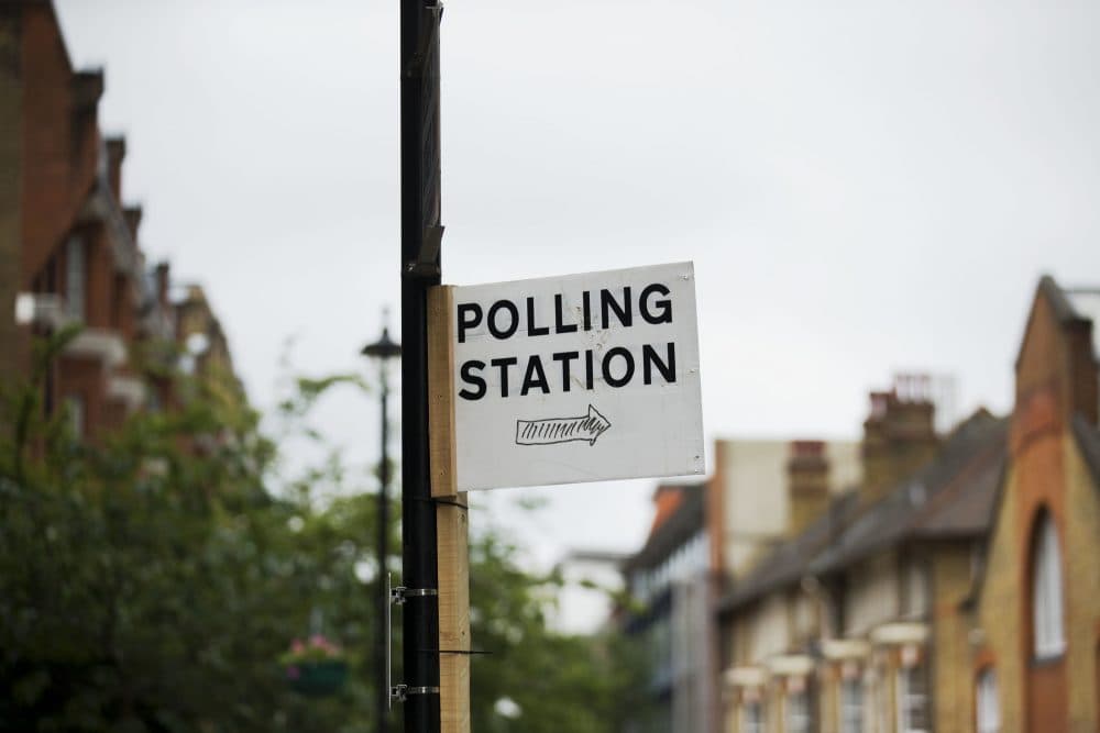 A sign points towards a referendum polling station in London, Wednesday, June 22, 2016. Britain votes whether to stay in the European Union in a referendum on Thursday. (Matt Dunham/AP)
