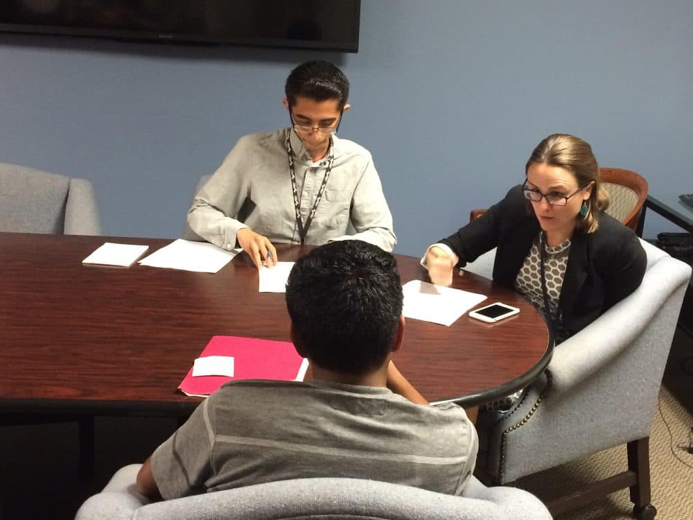 Legal assistant Javier Hernandez and lawyer Sara Van Hofwegen of Public Counsel meet with a teenage client from Guatemala who is applying for asylum. (Jude Joffe-Block/Fronteras)