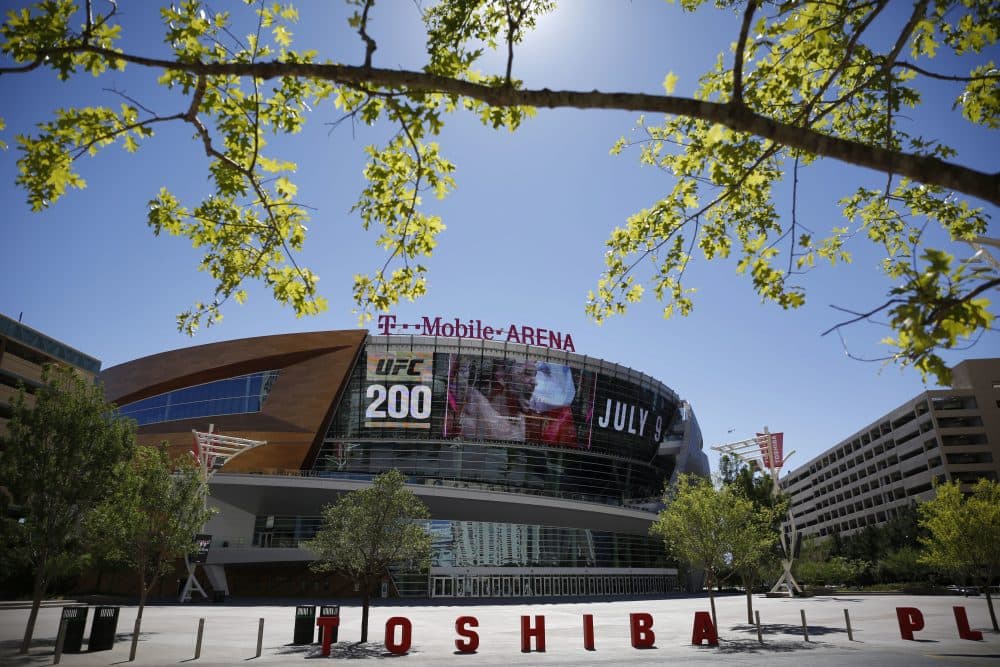 In this June 17, 2016 photo, an advertisement plays on a screen at the T-Mobile Arena in Las Vegas. A National Hockey League plan to expand to Las Vegas is being cheered by fans and backers of a years-long effort to get a pro sports franchise in Sin City, but hockey will have to elbow into a crowded entertainment lineup featuring casino games, celebrity shows, Cirque du Soleil productions and pulsing nightclubs – not to mention boxing matches, UFC fights and events like the National Finals Rodeo. (John Locher/AP)
