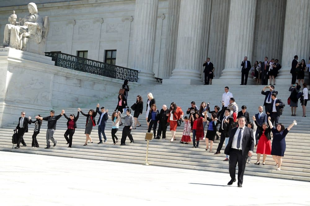 Immigration supporters hold up their hands and walk down the steps of the U.S. Supreme Court April 18, 2016 in Washington, DC. The Supreme Court heard oral arguments in the case of United States v. Texas, which is challenging President Obama's 2014 executive actions on immigration - the Deferred Action for Children Arrivals (DACA) and Deferred Action for Parents of American and Lawful Permanent Residents (DAPA) programs.  (Alex Wong/Getty Images)