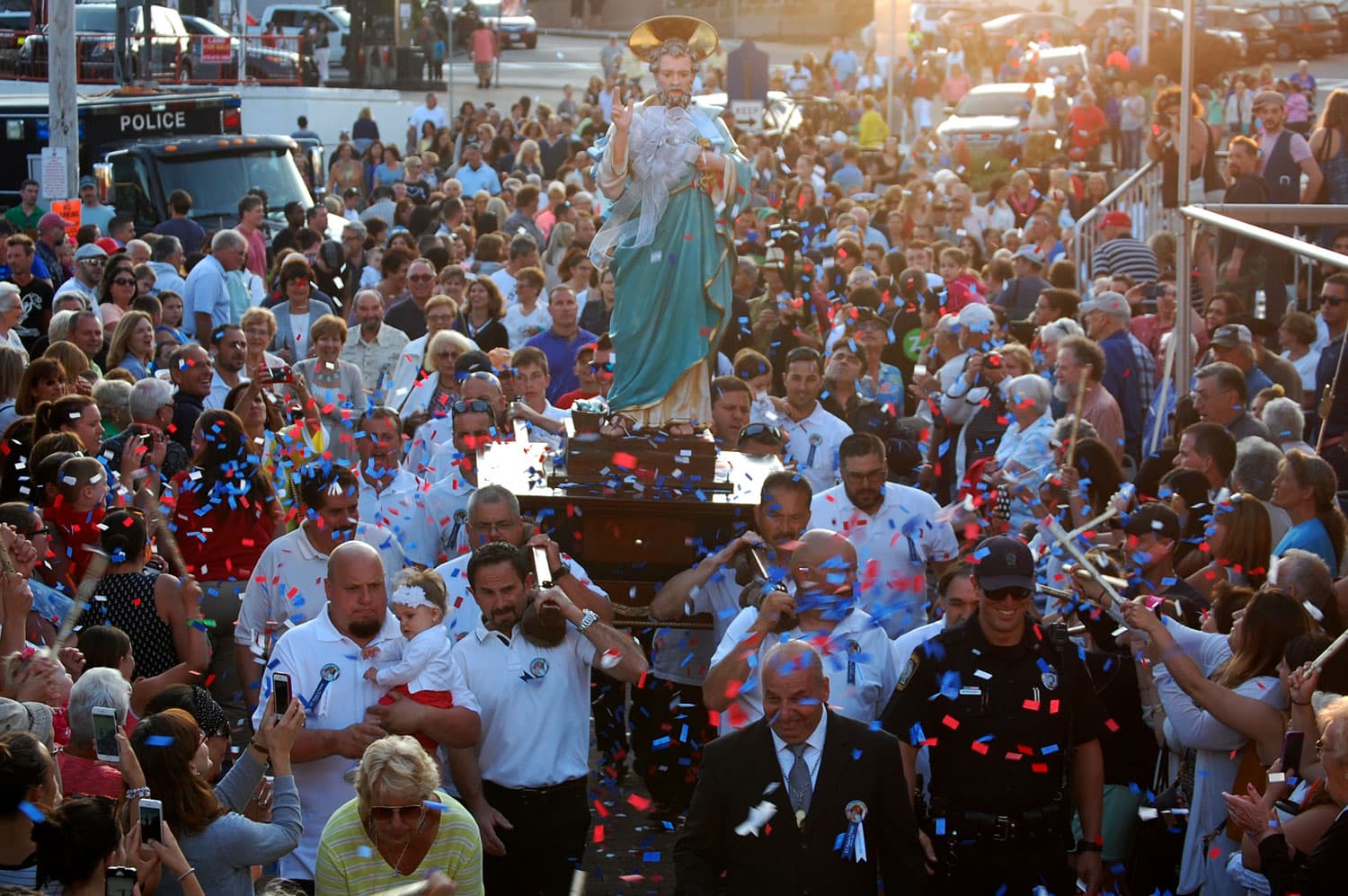 The statue of St. Peter is showered with confetti as it's carried into Gloucester's St. Peter's Square during the opening ceremonies of the St. Peter's Fiesta, June 24, 2016. (Greg Cook)