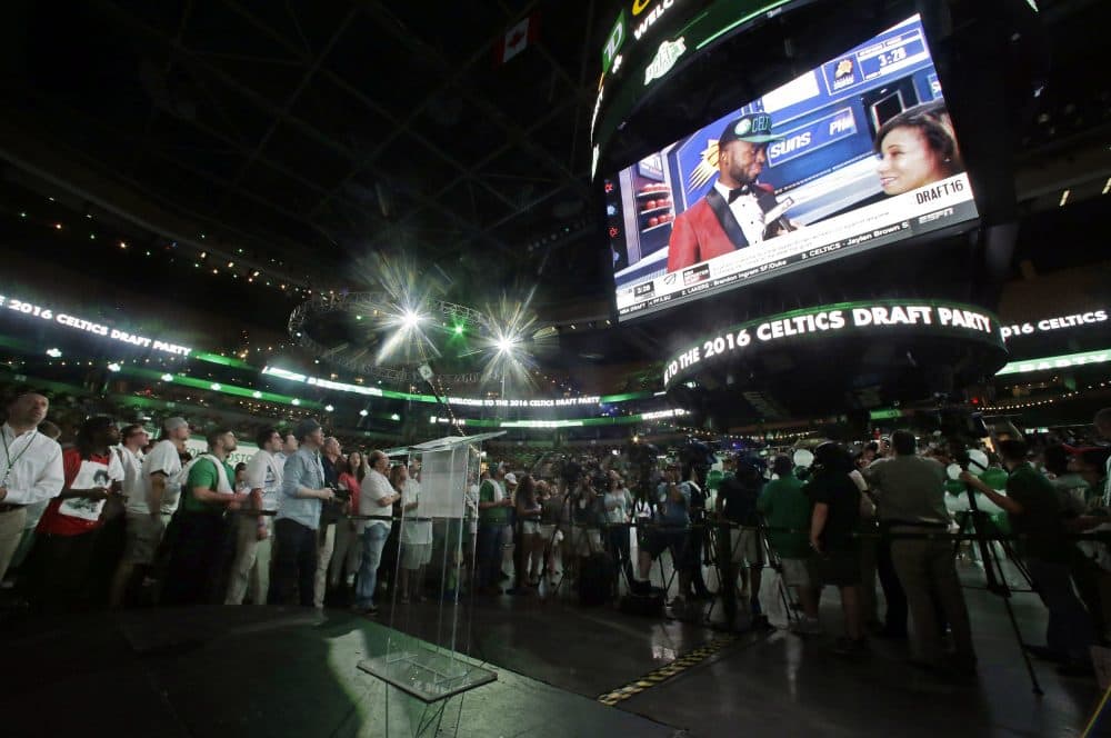 Fans watch as Jaylen Brown appears on a big screen at TD Garden Thursday night after being selected third overall by the Celtics. (Elise Amendola/AP)