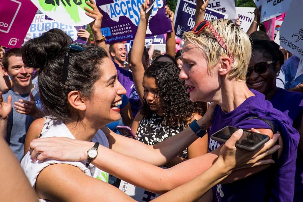 Abortion rights activists Morgan Hopkins of Boston, left, and Alison Turkos of New York City, celebrate on the steps of the United States Supreme Court on June 27, 2016 in Washington, DC. In a 5-3 decision, the U.S. Supreme Court struck down one of the nation's toughest restrictions on abortion, a Texas law that women's groups said would have forced more than three-quarters of the state's clinics to close. (Pete Marovich/Getty Images)