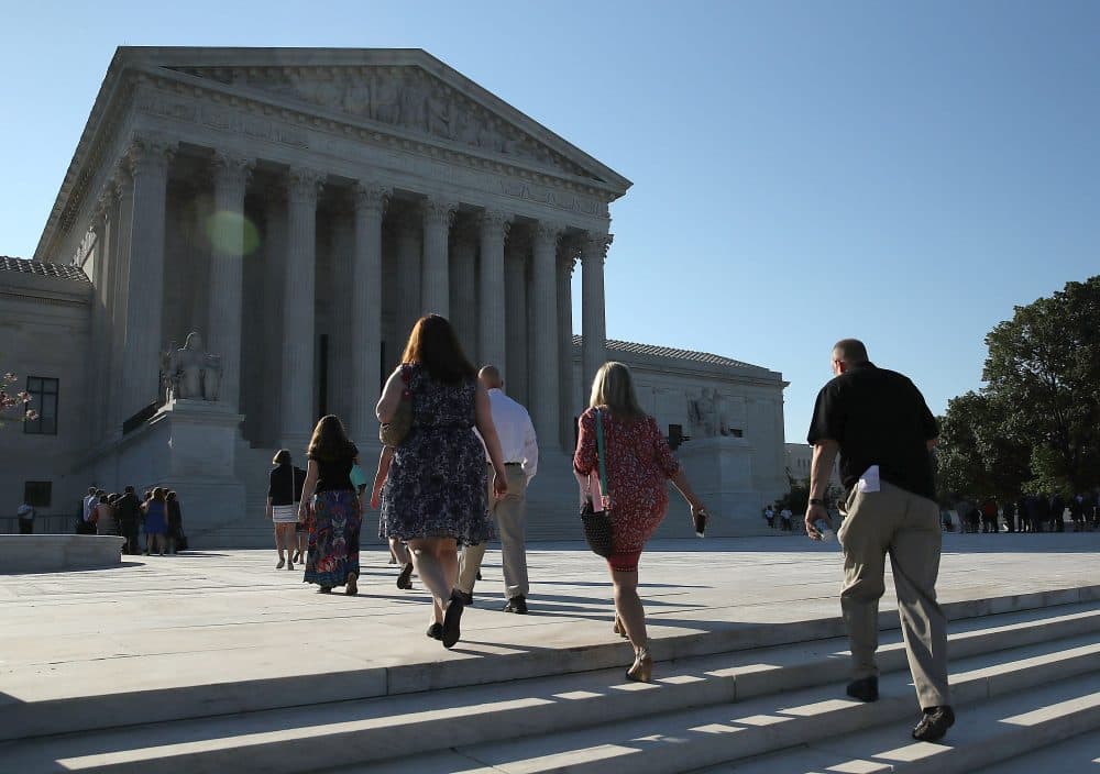 People walk up to the U.S. Supreme Court building June 20, 2016 in Washington, DC. The high court still has four decisions to hand down before their summer break next week.  (Mark Wilson/Getty Images)