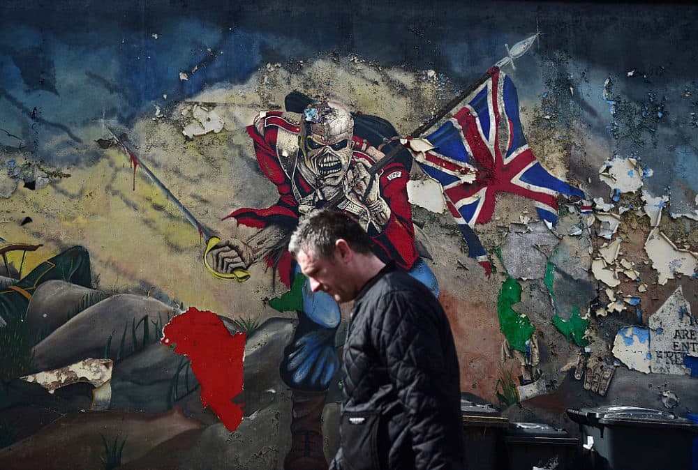 A man walks past a mural marking unionist territory on May 4, 2016 in Londonderry, Northern Ireland. The city of Londonderry is situated on the border between the north and south of Ireland. (Charles McQuillan/Getty Images)