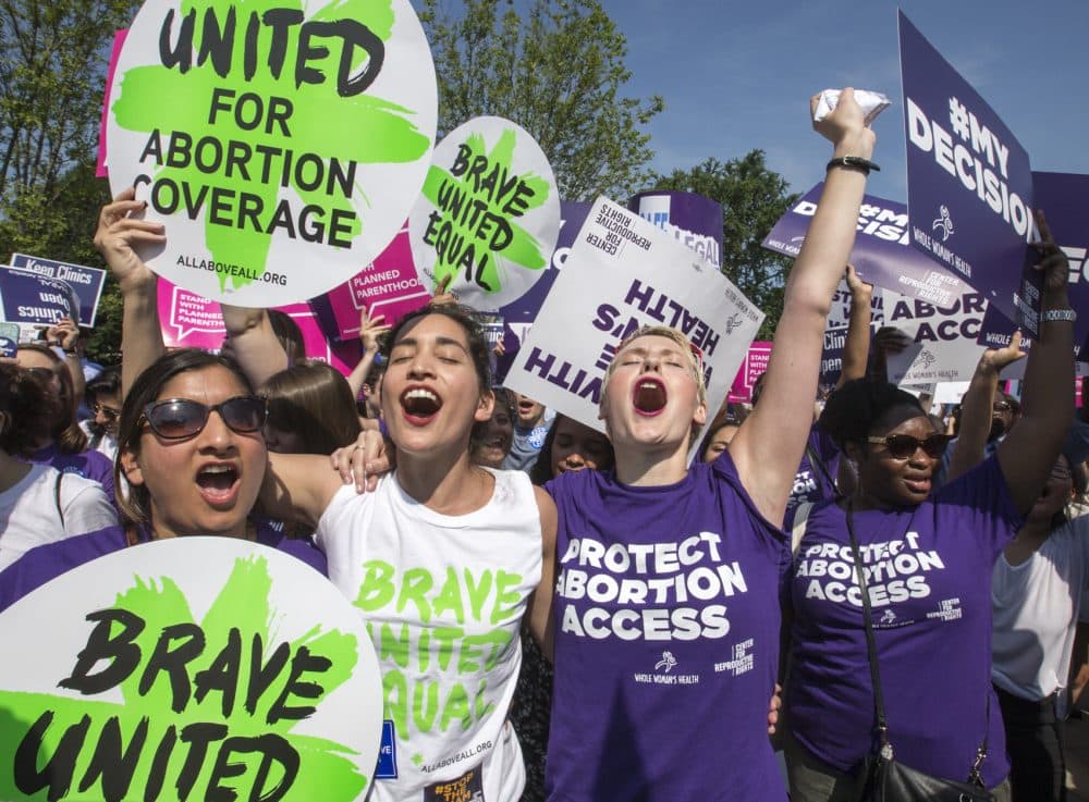 Abortion rights activists rejoice in front of the Supreme Court in Washington Monday as the justices struck down the strict Texas anti-abortion restriction law known as HB2. (J. Scott Applewhite/AP)