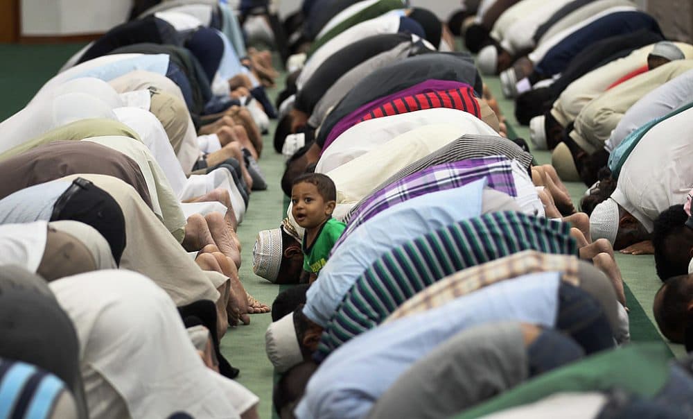 Hyder Huzri, 2, waits as his father and others pray during an evening prayer on the first day of Ramadan at the Islamic Center of Greater Miami on August 1, 2011 in Miami, Florida. (Joe Raedle/Getty Images)
