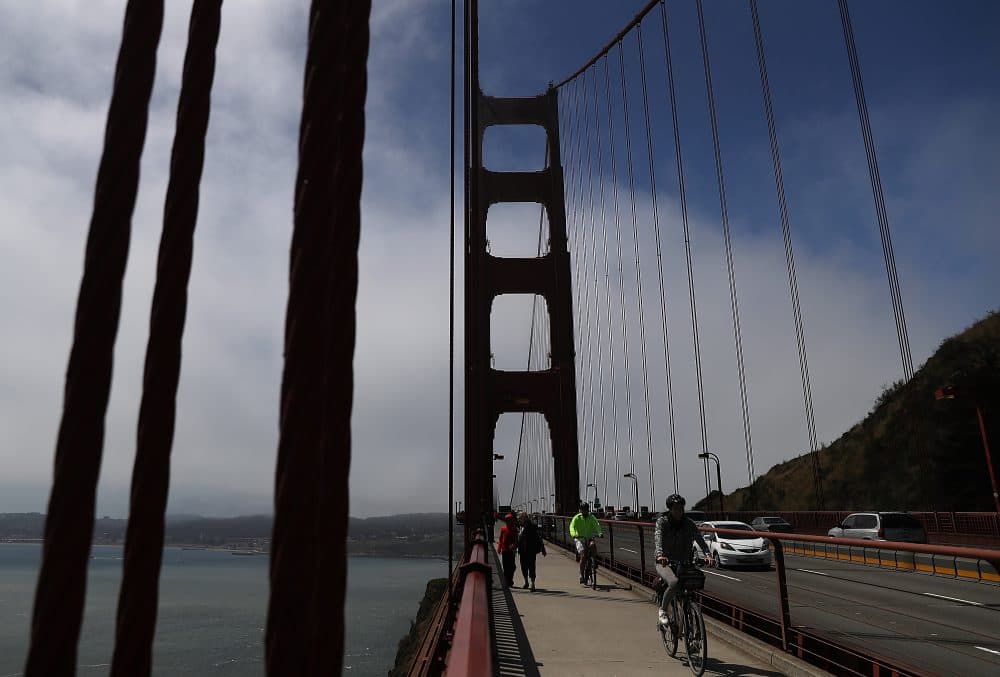 Cyclists ride by the north tower of the Golden Gate Bridge on June 28, 2016 in San Francisco, California. (Justin Sullivan/Getty Images)